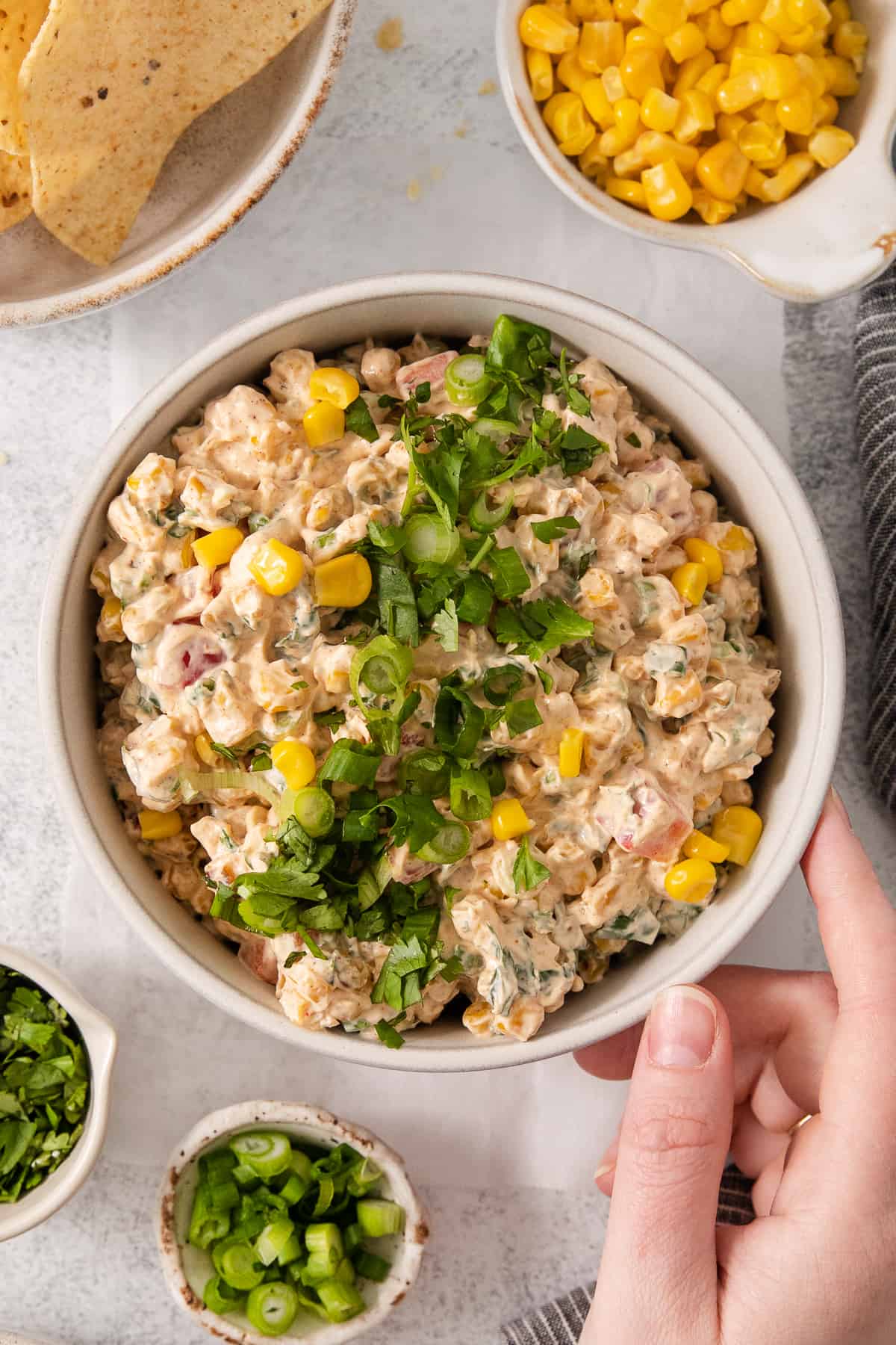 a bowl of tuna salad with corn and jalapenos.