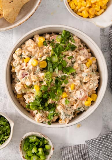 a bowl of tuna salad with corn and jalapenos.