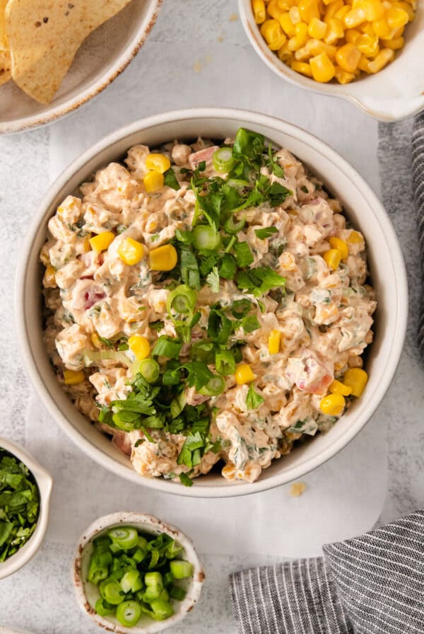 a bowl of tuna salad with corn and jalapenos.