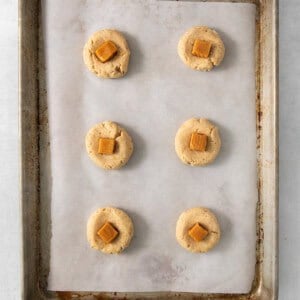 a baking sheet with six cookies on it.