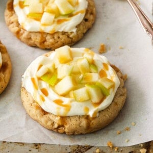 a close up of a cookie with apples on top.