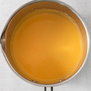 a pan of liquid sitting on top of a metal stand.