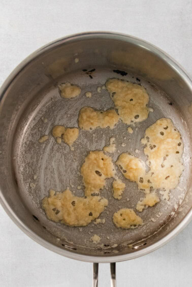 a pan filled with food on top of a stove.