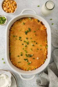 a casserole dish with peas, peas, and sour cream.