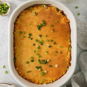 a casserole dish with peas, peas, and sour cream.