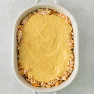 a casserole dish filled with a mixture of cheese.