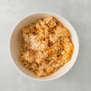 a white bowl filled with cereal on top of a table.