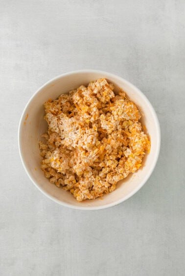 a white bowl filled with cereal on top of a table.