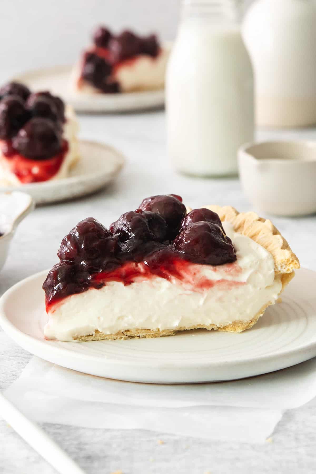 a white plate topped with a slice of pie.