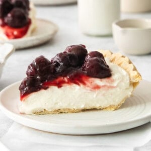 a white plate topped with a piece of pie.