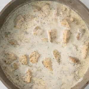 chicken in cream sauce in a skillet.