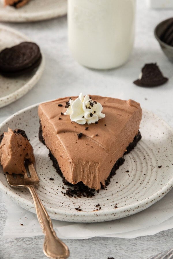 a slice of chocolate pie on a plate with a fork.