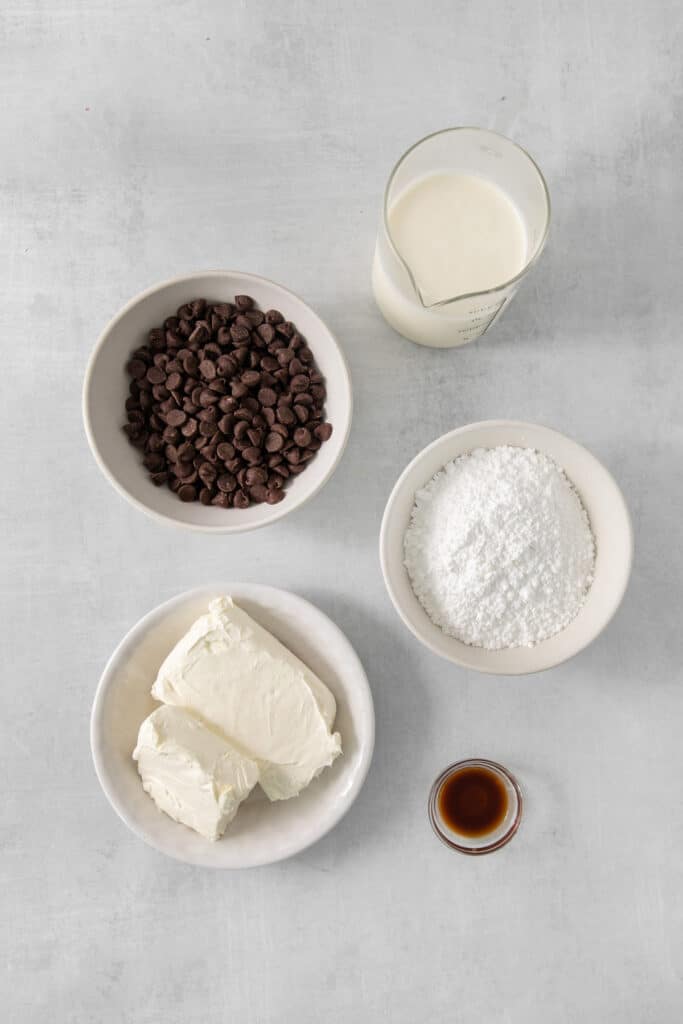 a table topped with bowls of food next to a cup of milk.