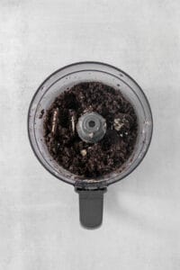 a food processor filled with dirt on top of a table.