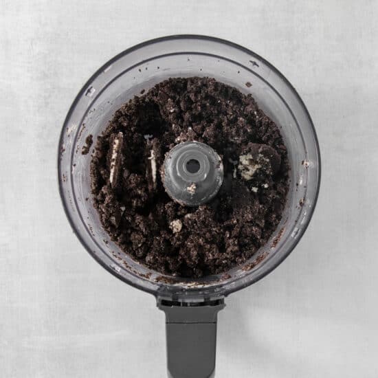 a food processor filled with dirt on top of a table.