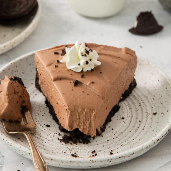 a piece of chocolate cake on a plate with a fork.