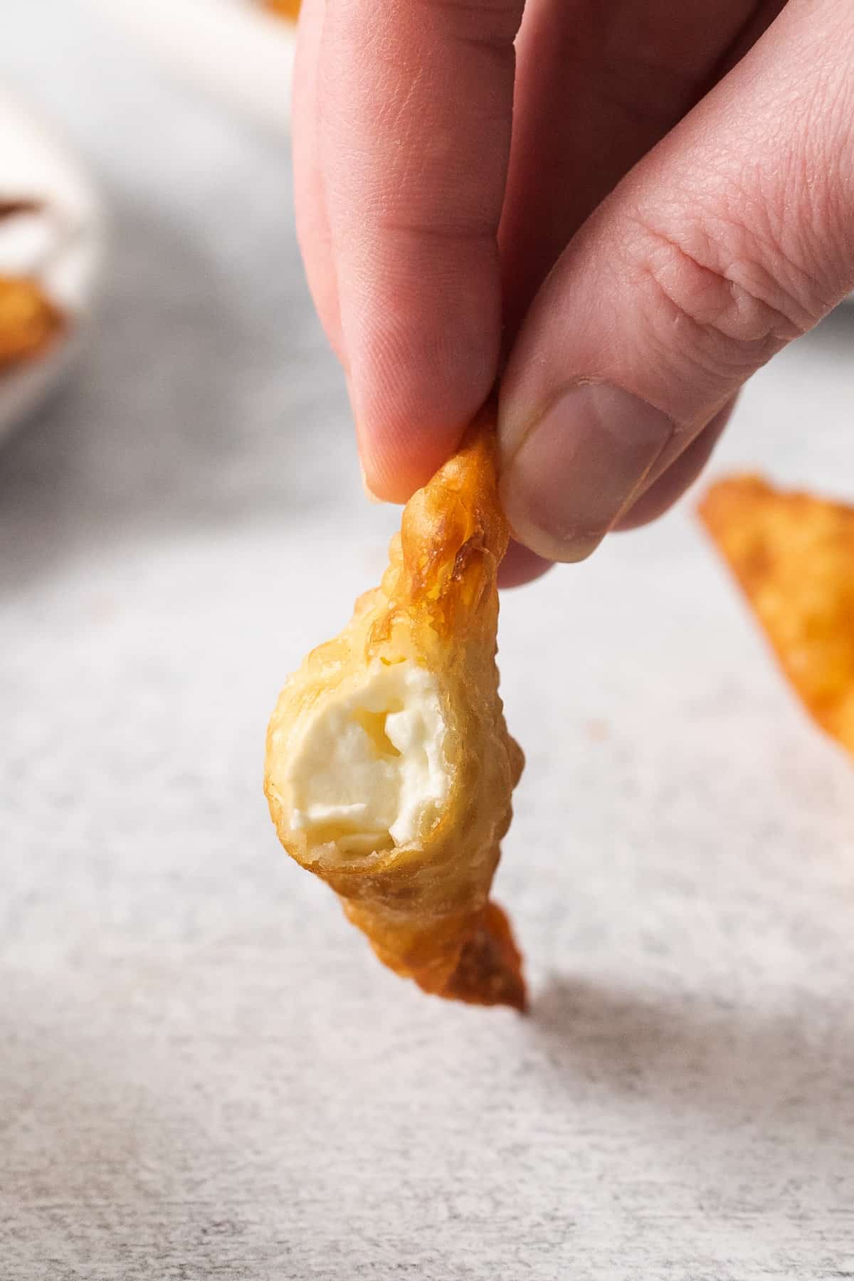 Cream cheese rangoon on a plate.