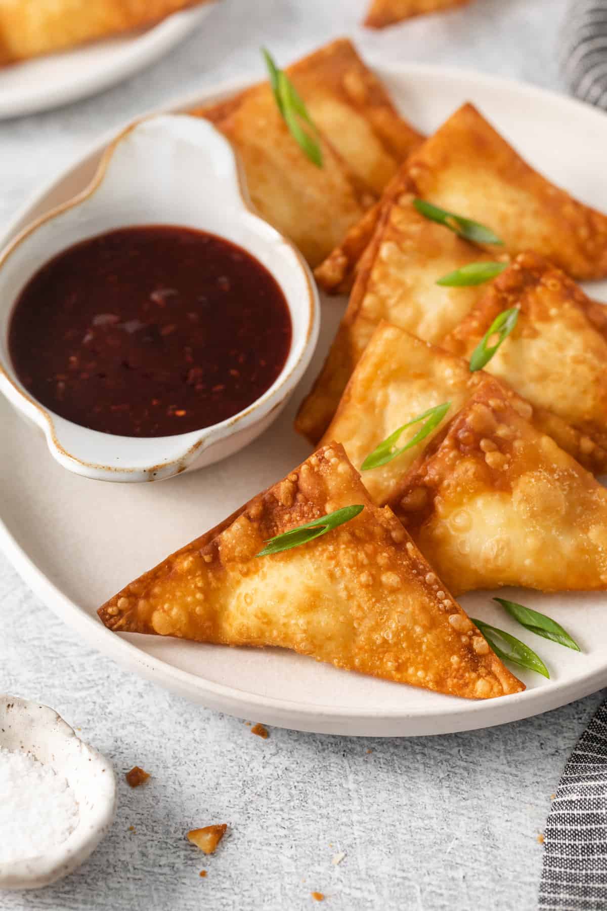 Cream cheese rangoon on a plate.