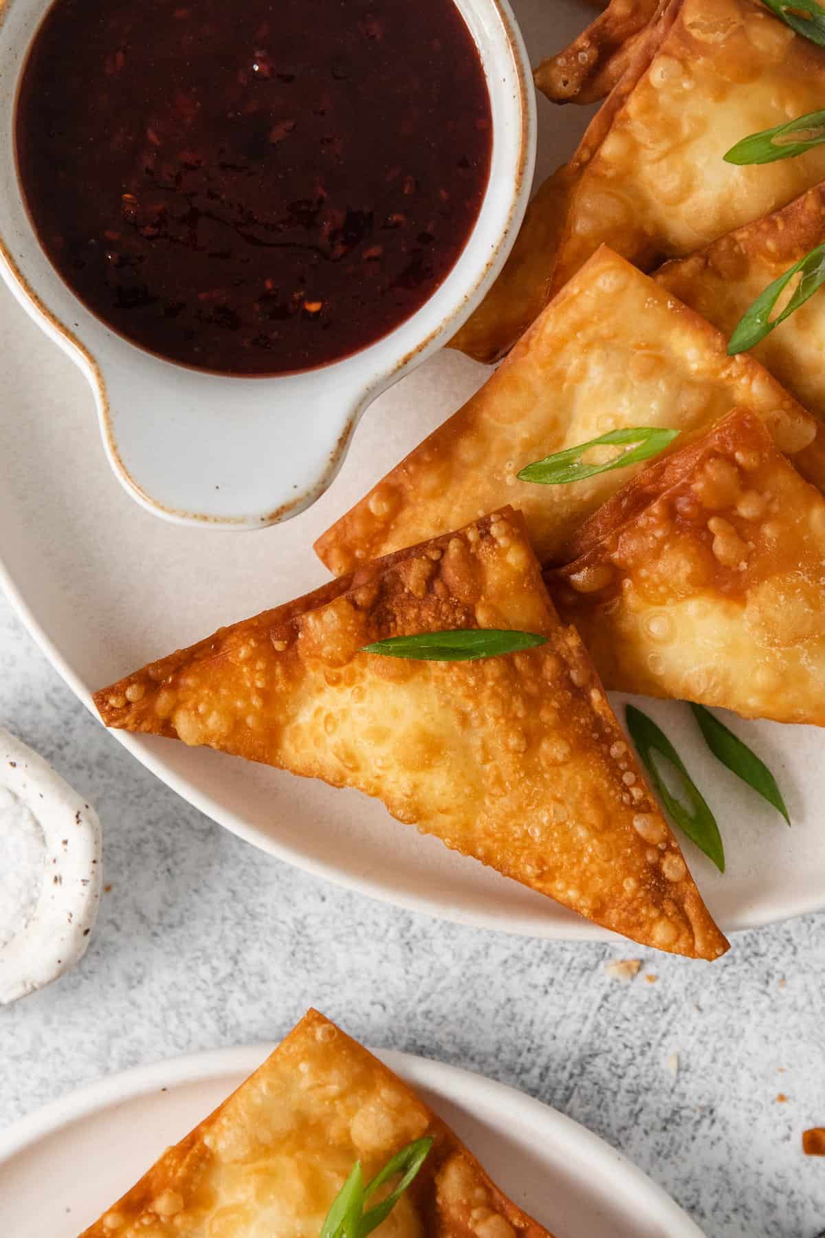 Cream cheese rangoon on a plate.