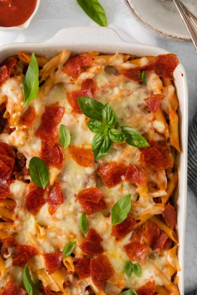 a casserole dish with pepperoni and cheese.