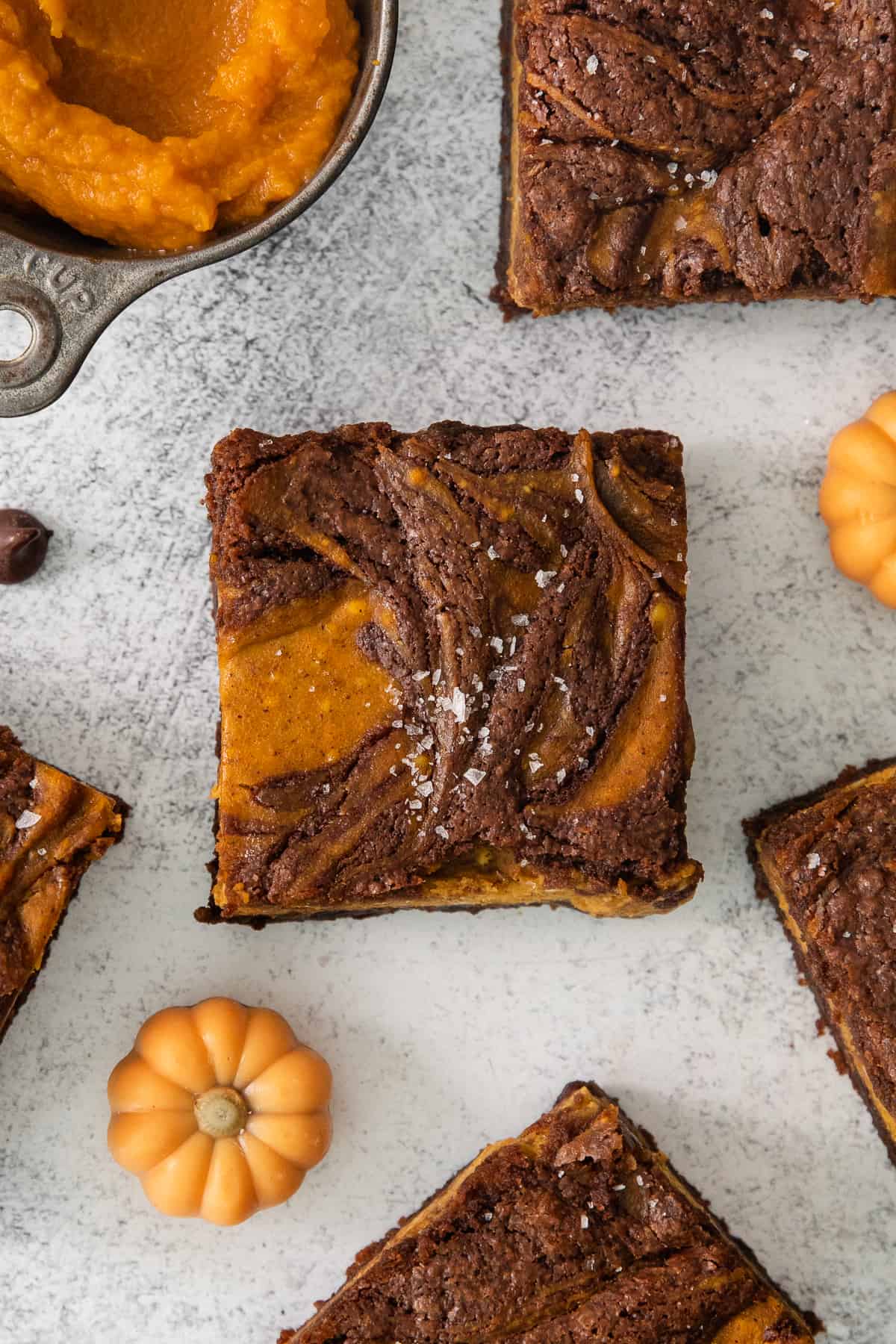 pumpkin butterscotch brownies on a white table.