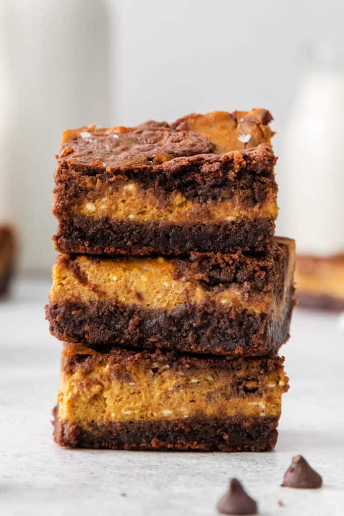 a stack of chocolate peanut butter brownies stacked on top of each other.