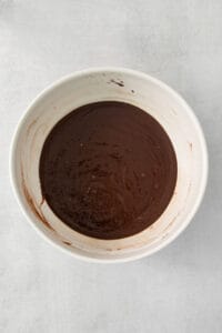 chocolate ganache in a white bowl.