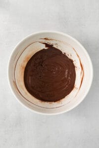 chocolate ganache in a white bowl.