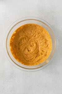 a glass bowl filled with a mixture of pumpkin.