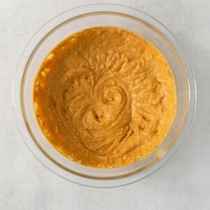 a glass bowl filled with a mixture of pumpkin.