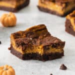 a slice of chocolate pumpkin brownies on a white background.