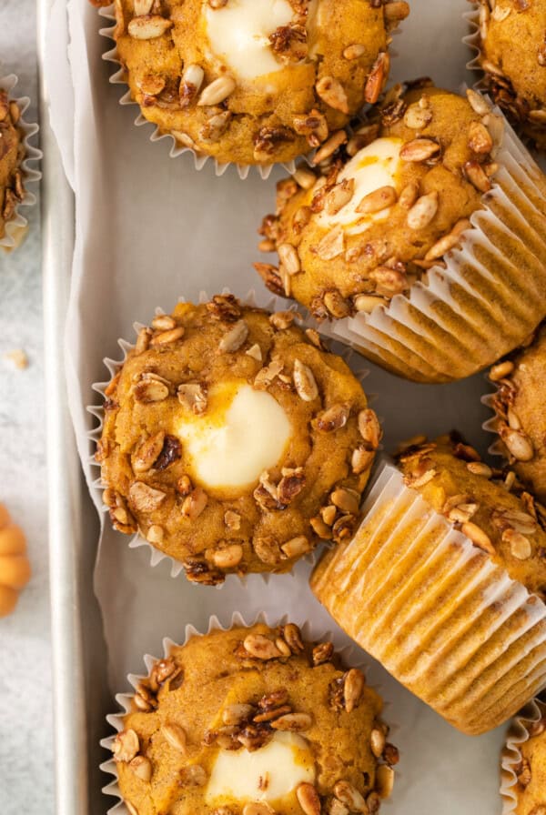 pumpkin buttermilk muffins on a baking sheet.