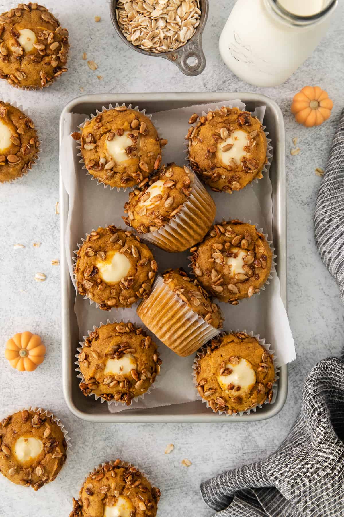 pumpkin muffins on a tray with milk and oats.