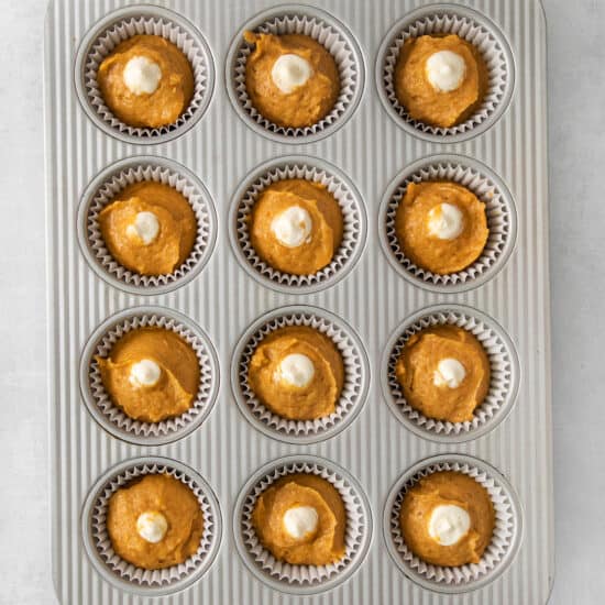pumpkin cupcakes in a muffin tin.