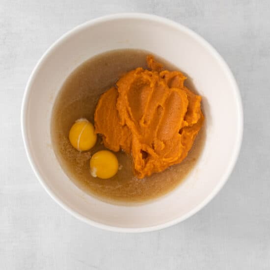 a bowl with mashed sweet potato and eggs in it.