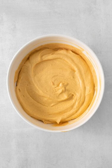 a bowl of hummus on a table.