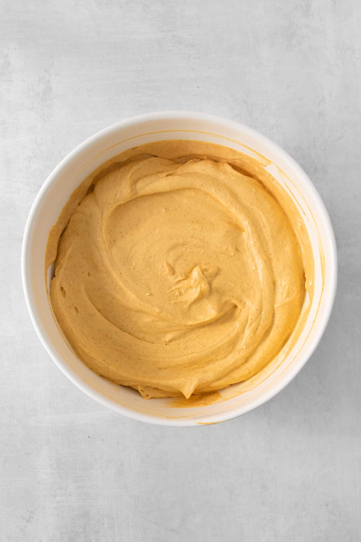 a bowl of hummus on a table.