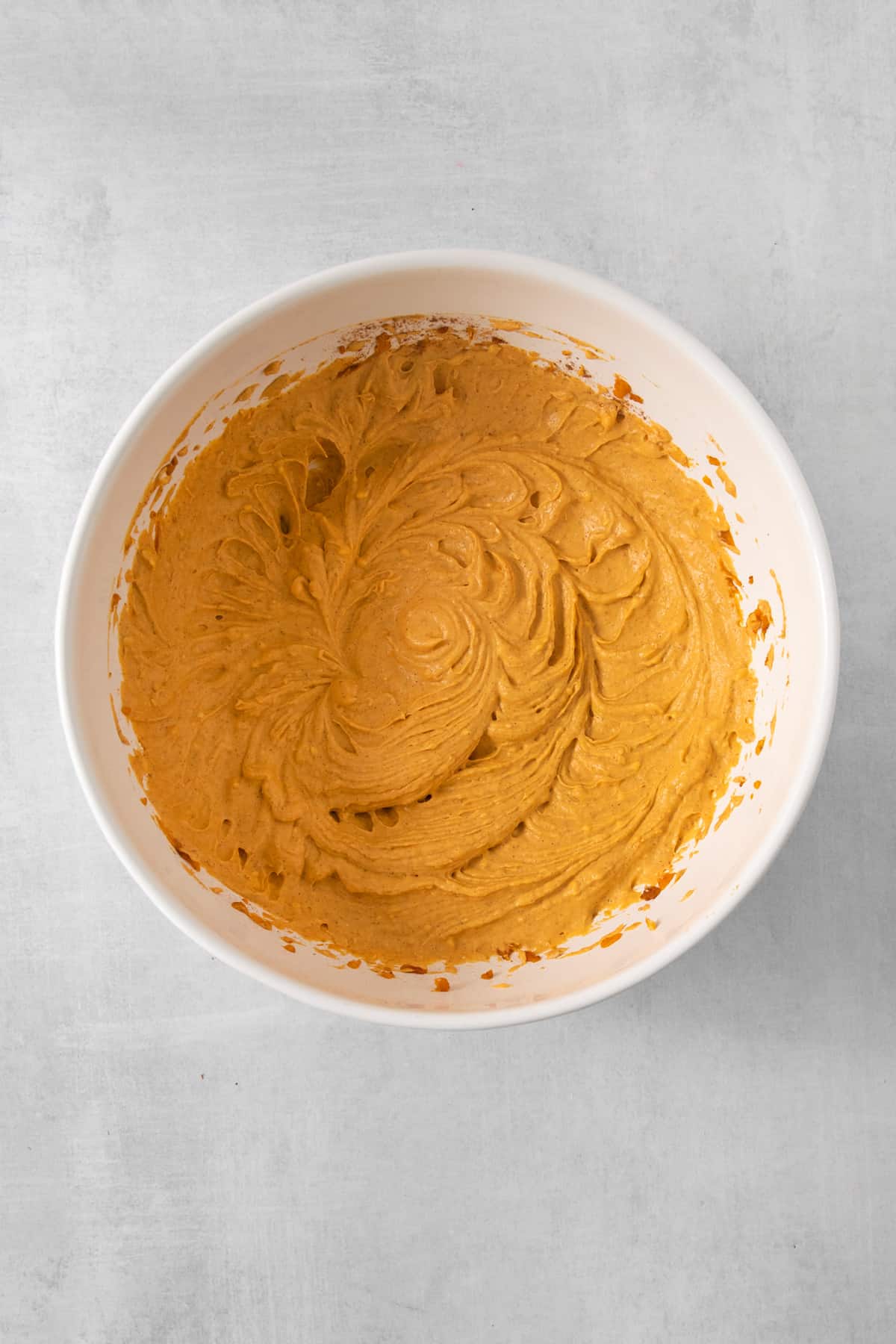 a bowl of hummus on a table.