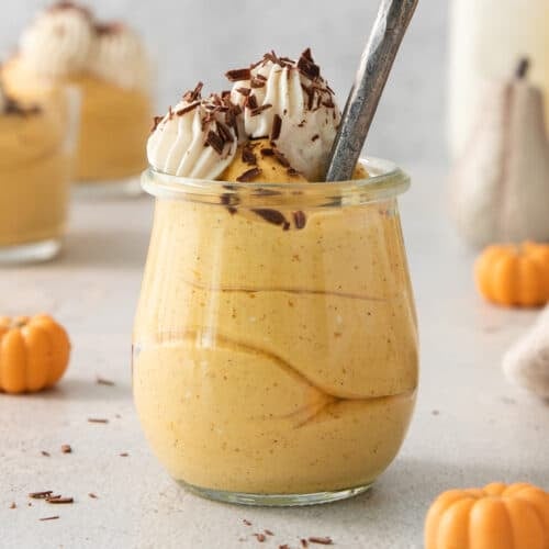 a dessert in a jar with a spoon in it.