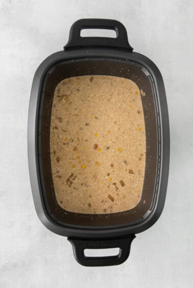 a slow cooker with a bowl of food in it.