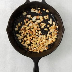 a frying pan filled with chopped vegetables on top of a table.