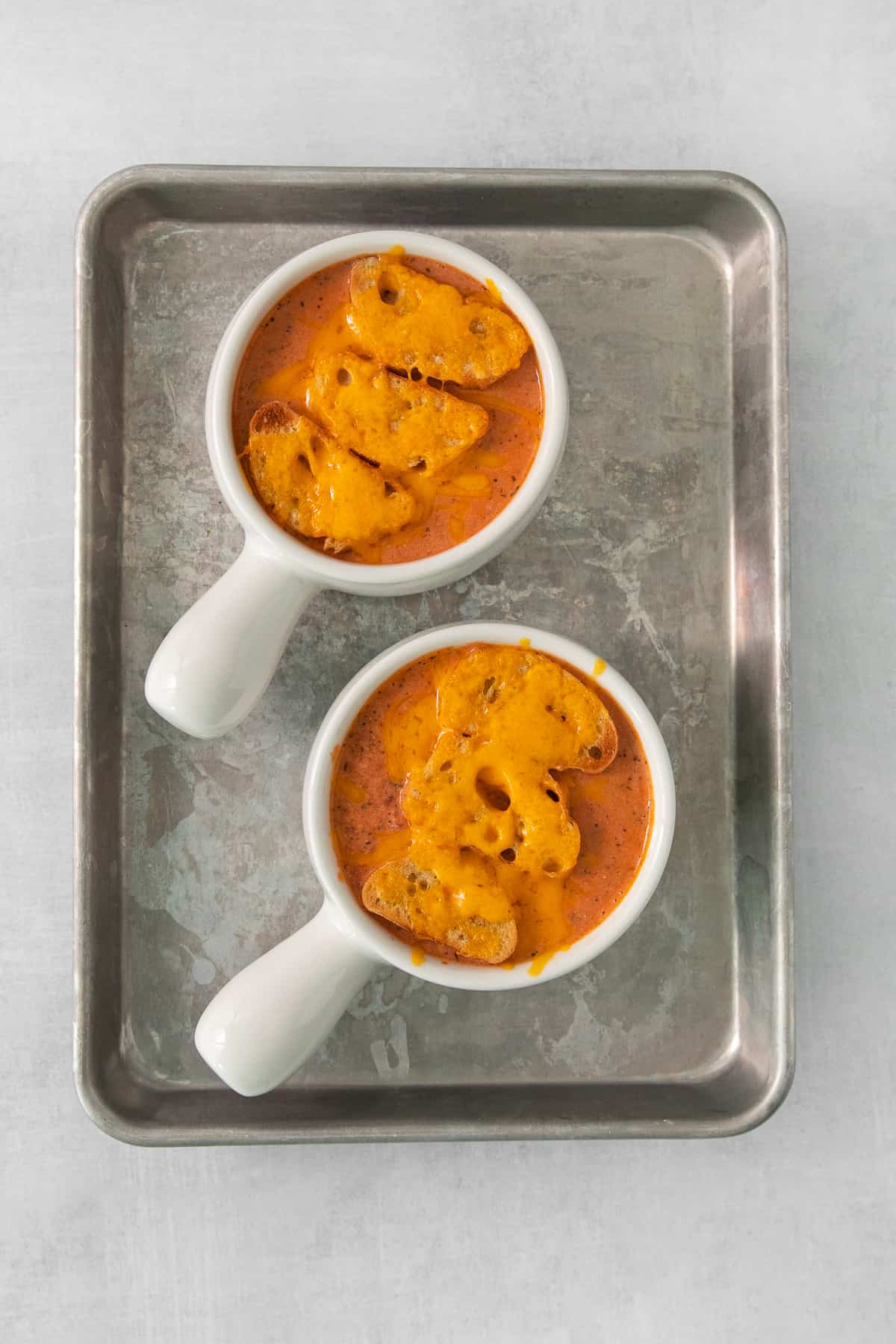 two bowls of soup on a tray.