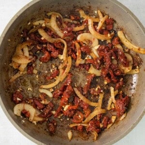 a pan filled with food sitting on top of a stove.