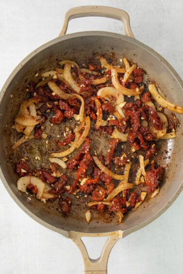 a pan filled with food sitting on top of a stove.