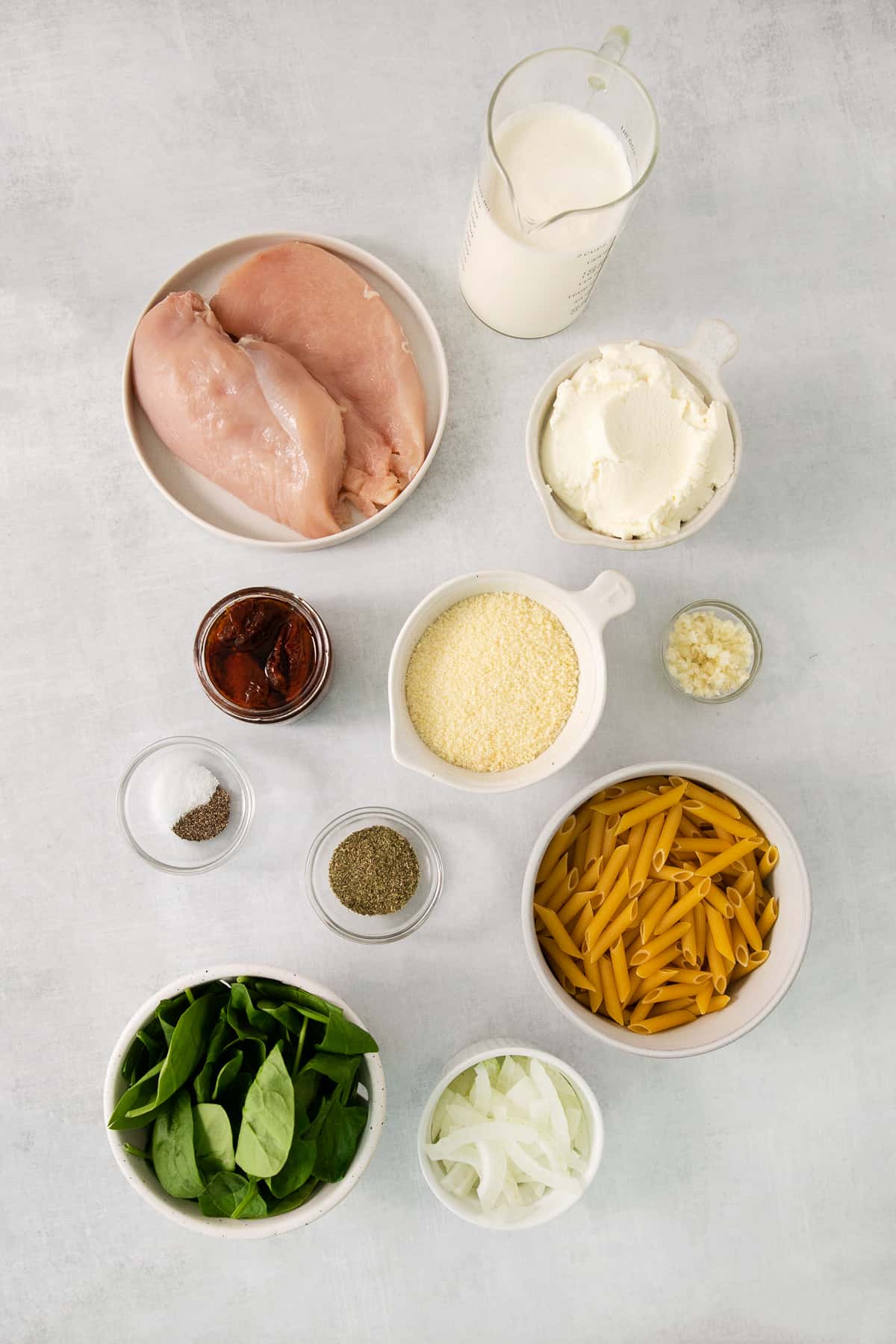 a white table topped with bowls of food.