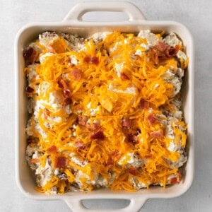 a casserole dish filled with bacon and cheese.