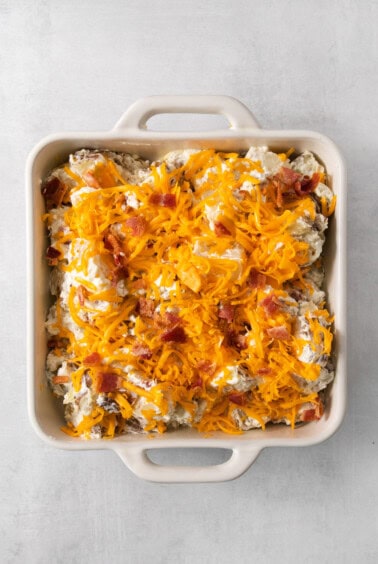 a casserole dish filled with bacon and cheese.