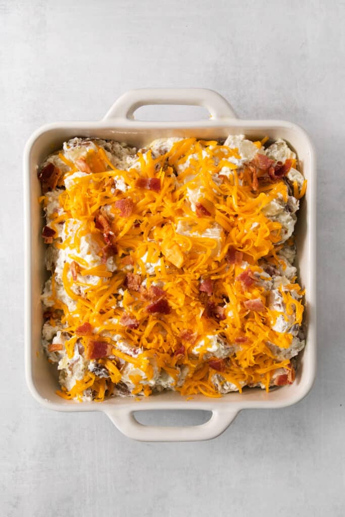 a casserole dish filled with bacon and cheese.