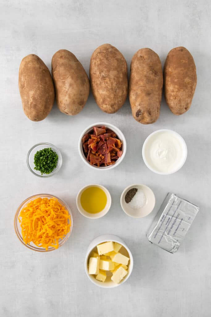 the ingredients for mashed potatoes are laid out on a table.