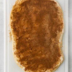 a piece of bread on a white cutting board.